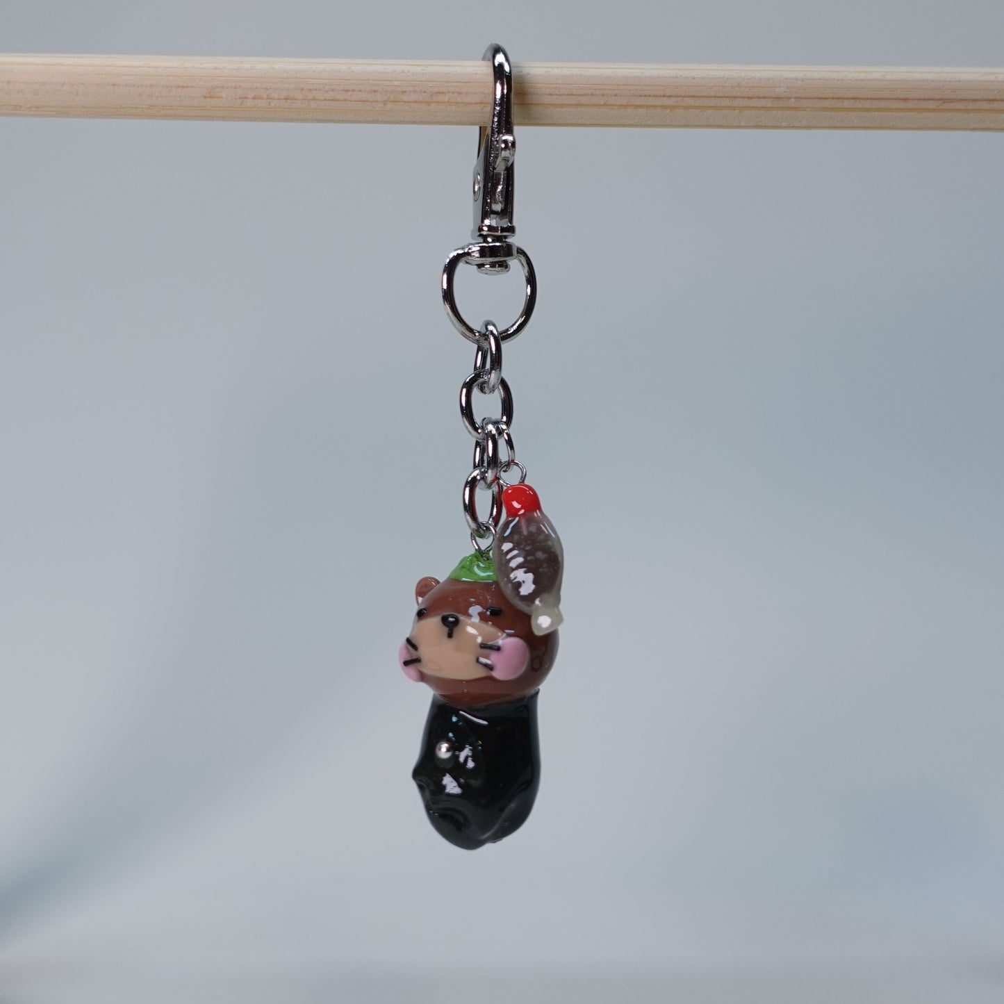 Handmade Sushi Otter keychain with extra soy fish charm, cute pastel accessory for bags or keys, limited edition collectible design.