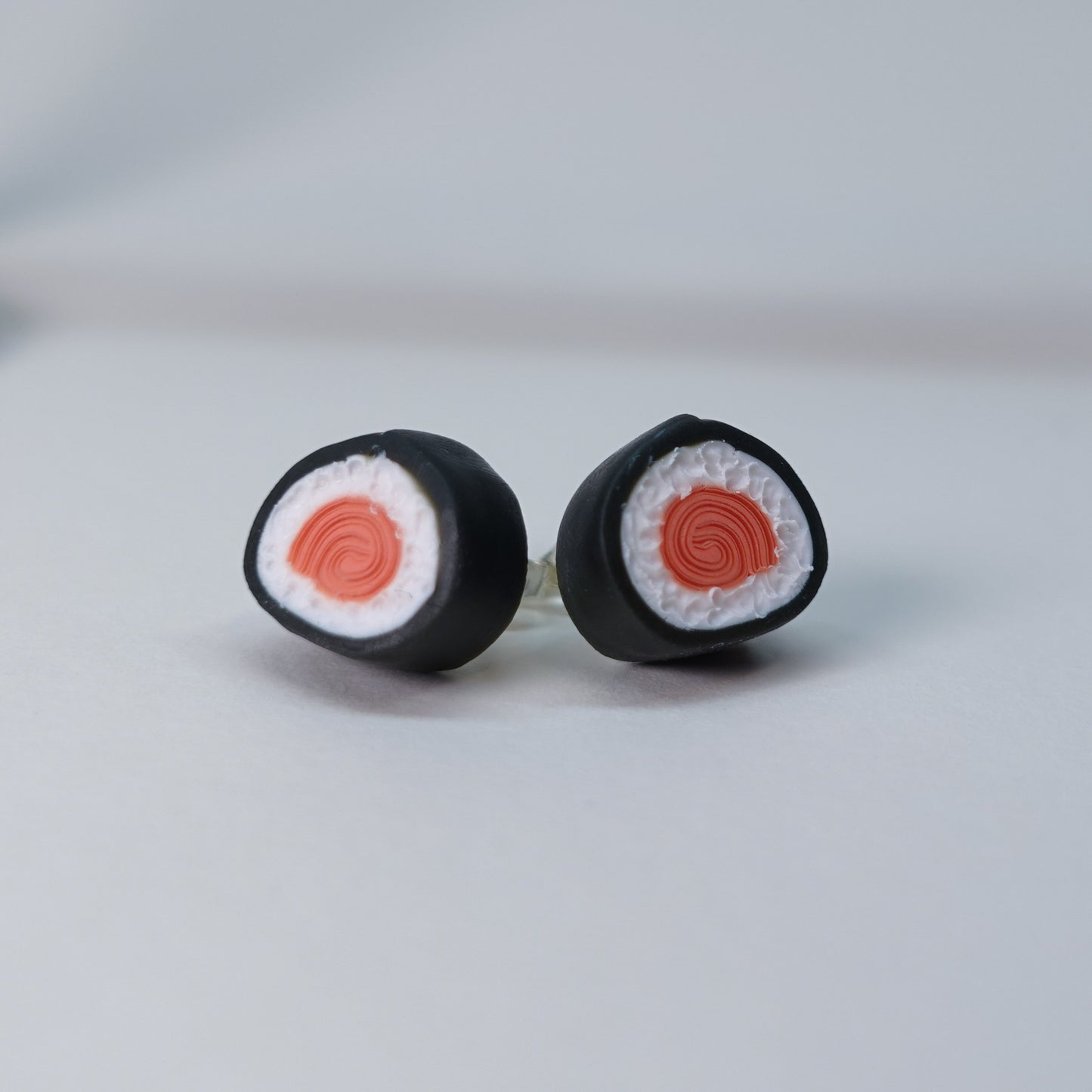 Handmade fish-shaped soy bottle earrings with matching salmon maki roll stud earrings, pastel sushi-themed set, limited edition, 4 sets available, playful accessory for daily wear.