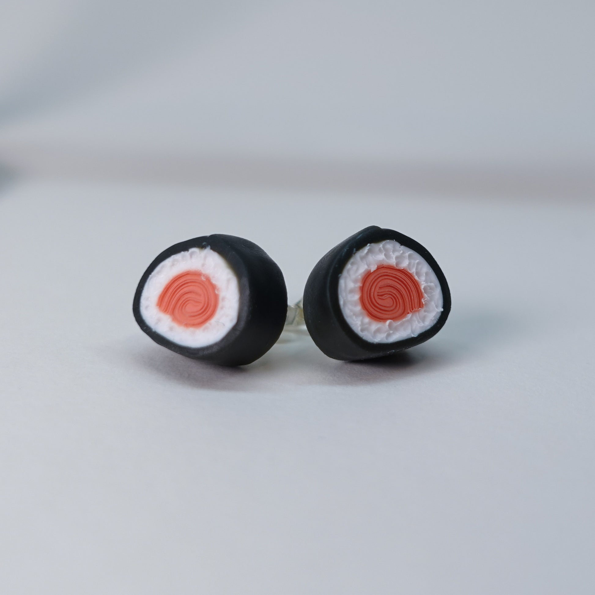 Handmade fish-shaped soy bottle earrings with matching salmon maki roll stud earrings, pastel sushi-themed set, limited edition, 4 sets available, playful accessory for daily wear.