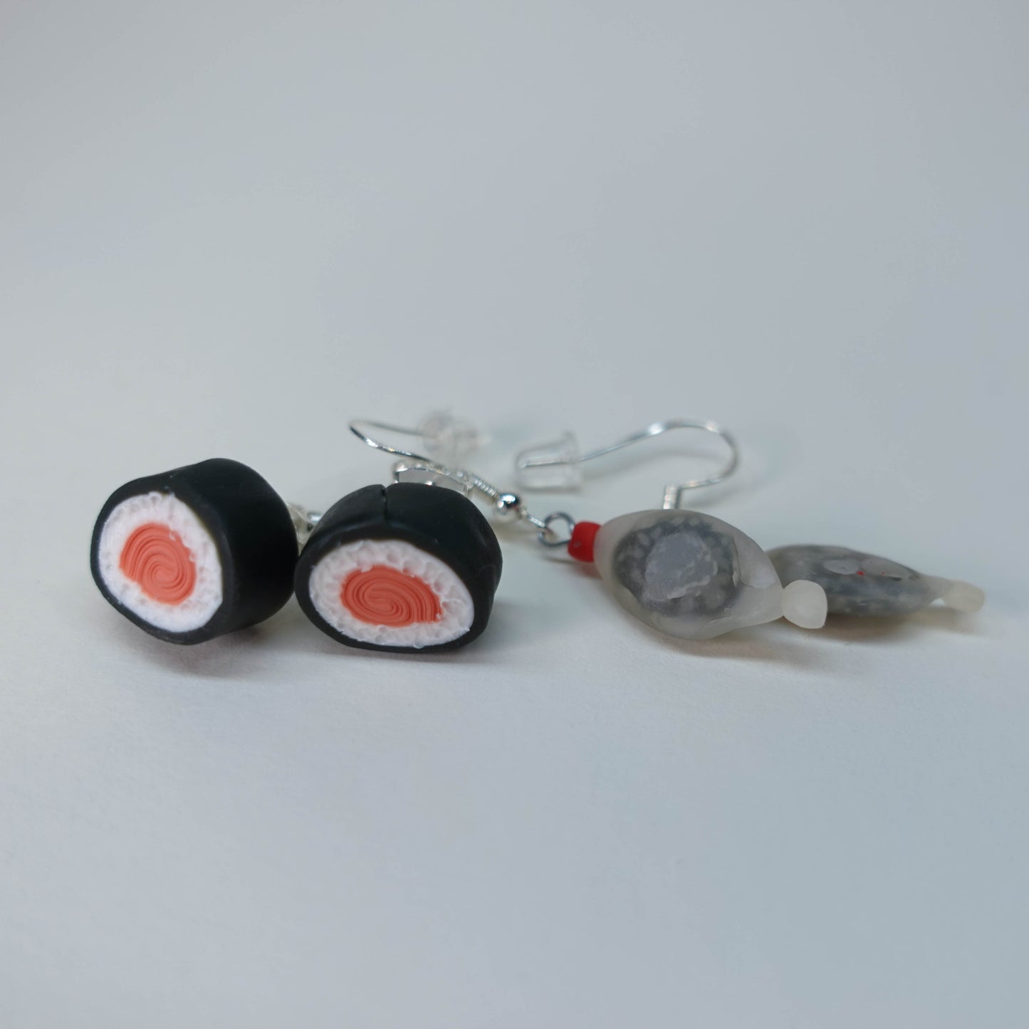 Handmade fish-shaped soy bottle earrings with matching salmon maki roll stud earrings, pastel sushi-themed set, limited edition, 4 sets available, playful accessory for daily wear.