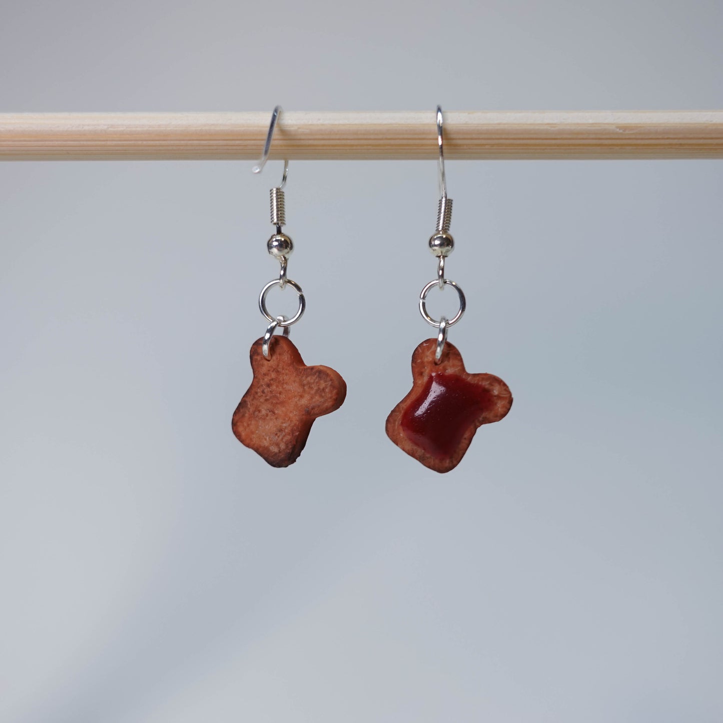 Handmade Toast with Jam earrings set featuring five unique pairs: slightly burned toast, blueberry jam, and strawberry jam, pastel food-themed accessory, 5 pairs available.