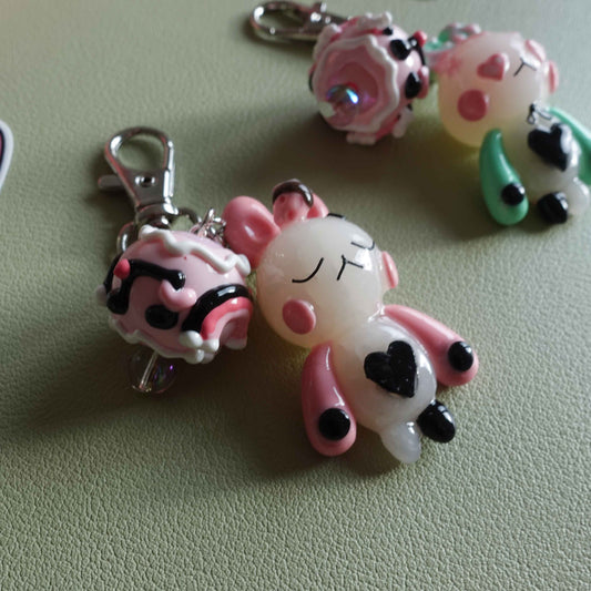 Pair of bunny-shaped keychains in soft pastel shades with magnetic bellies that 'click' together, symbolizing the connection and love shared with your significant other