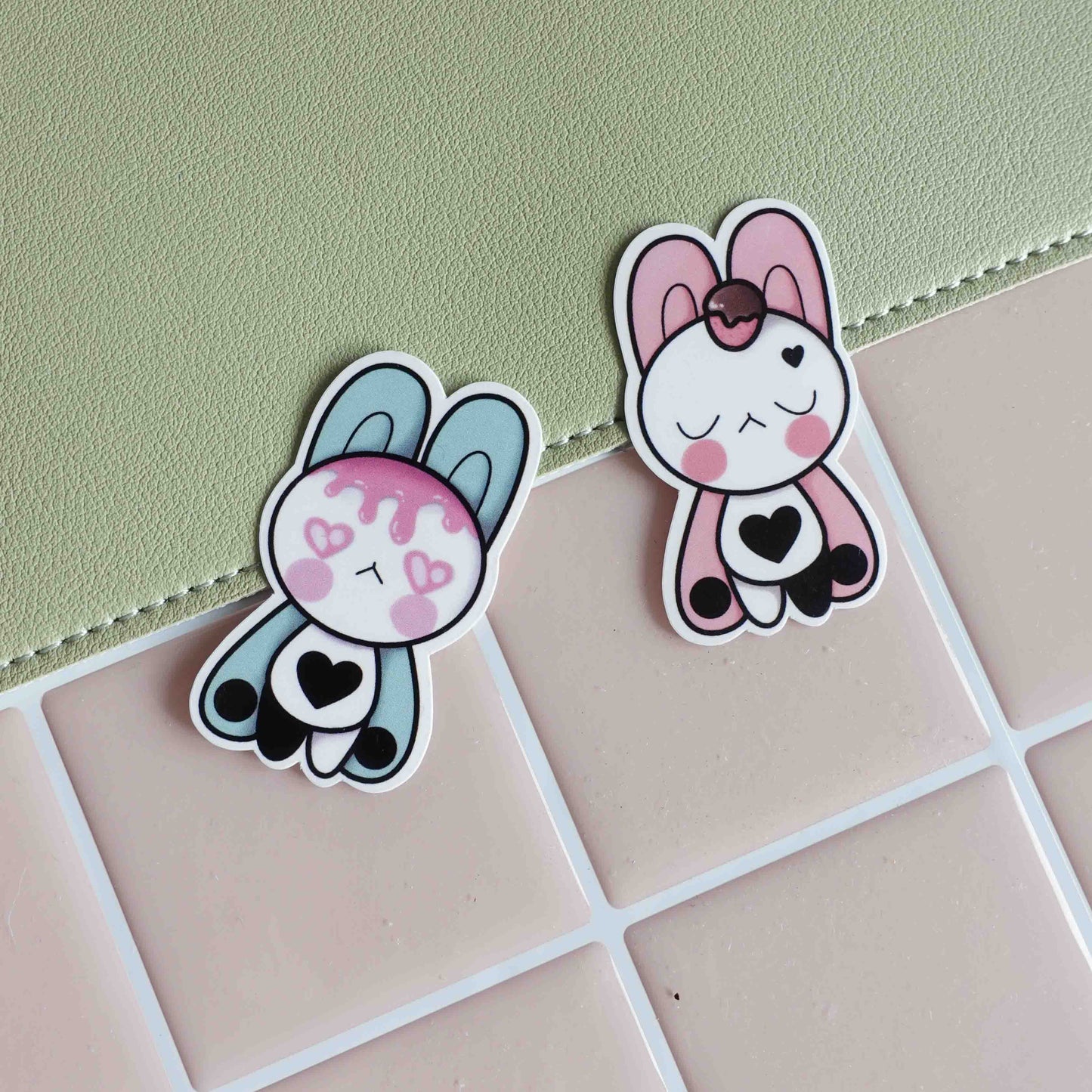 Illustrated sticker featuring two pastel bunnies with their bellies gently touching, representing a loving bond and a magnetic connection, designed in a whimsical and romantic style.