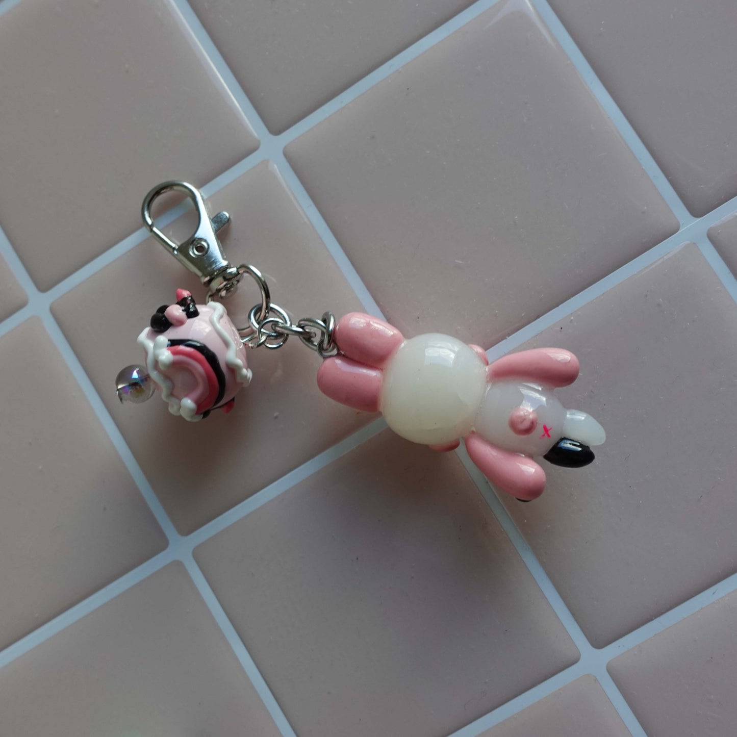 Pair of bunny-shaped keychains in soft pastel shades with magnetic bellies that 'click' together, symbolizing the connection and love shared with your significant other