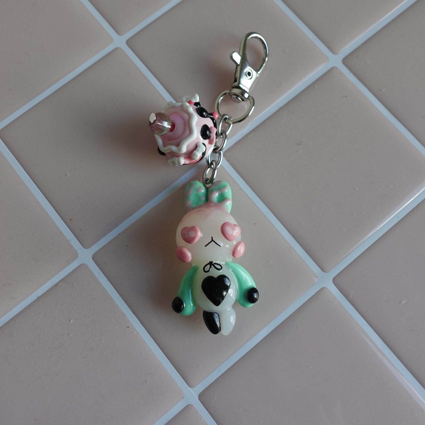 Pair of bunny-shaped keychains in soft pastel shades with magnetic bellies that 'click' together, symbolizing the connection and love shared with your significant other