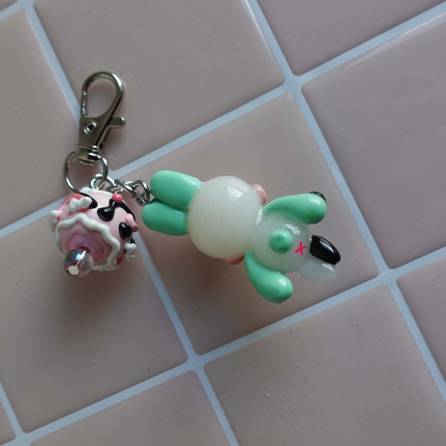 Pair of bunny-shaped keychains in soft pastel shades with magnetic bellies that 'click' together, symbolizing the connection and love shared with your significant other