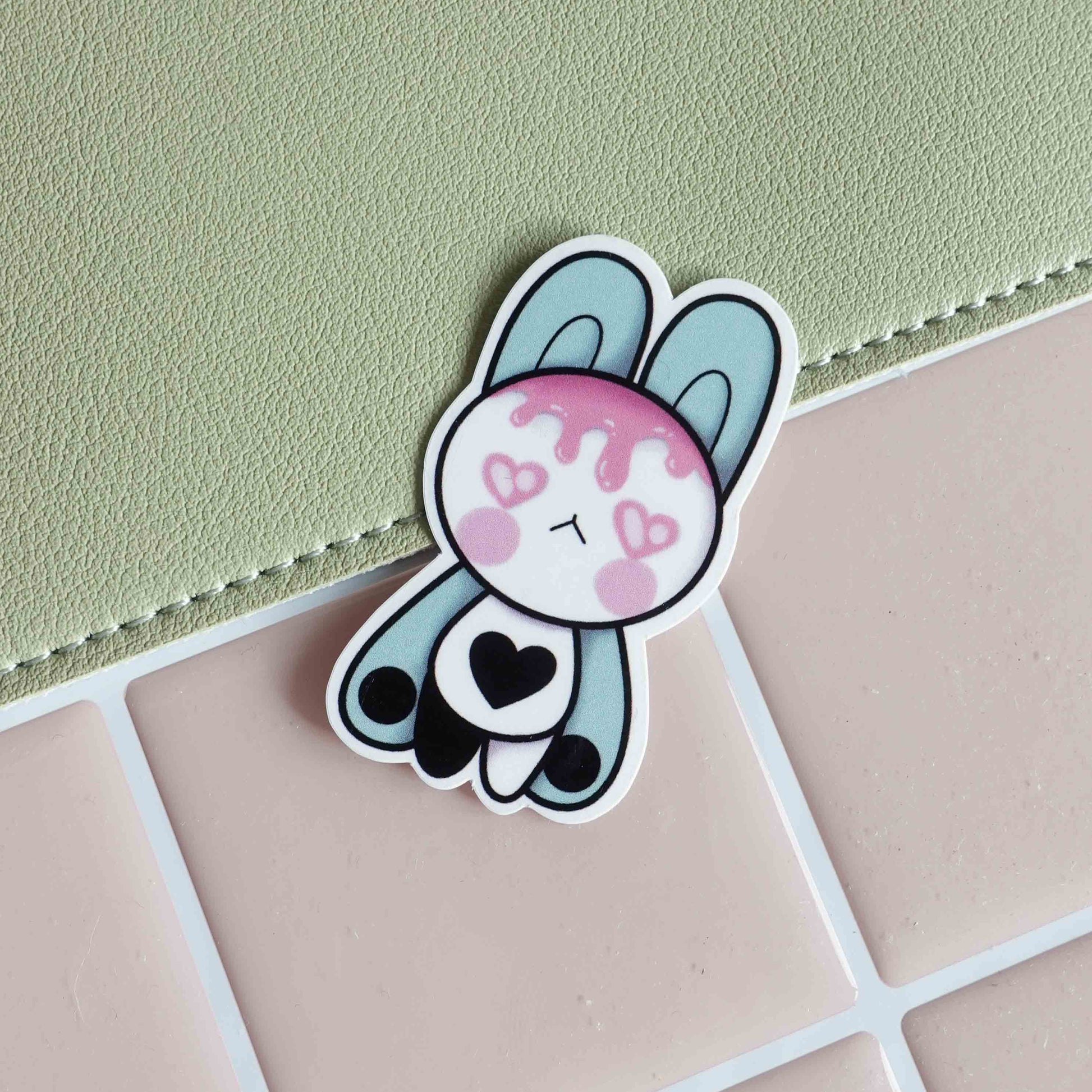 Illustrated sticker featuring two pastel bunnies with their bellies gently touching, representing a loving bond and a magnetic connection, designed in a whimsical and romantic style.