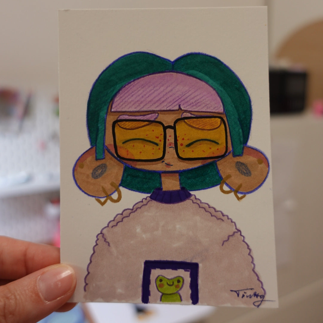 Original ACEO painting featuring a cute original character face, hand illustrated with professional markers and coloured pencils on high-quality artist paper.