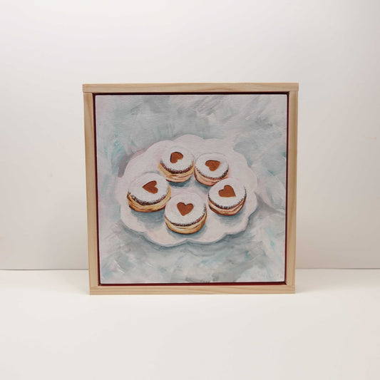 Framed acrylic painting of a Valentine’s Day krapfen, depicted as a sweet, romantic motif on a wooden canvas, 20 × 20 cm.